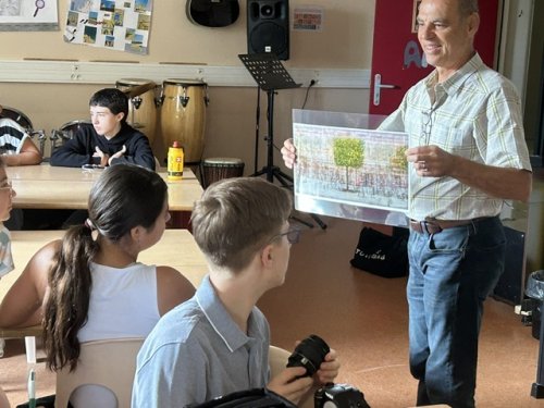 Olivier muhlhoff montrant une reproduction d'une de ses oeuvres de la série "Arborescenc" auxceleves de la CHAAP, en salle d'arts au collège.jpg
